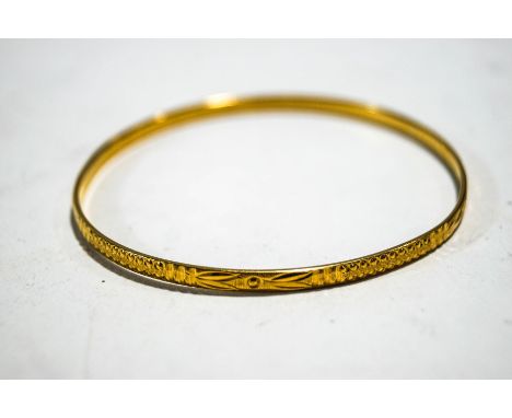 A 22 carat gold bangle, with diamond cut decoration, 3 mm wide, internal diameter 6.4 cm, 12.8 g gross