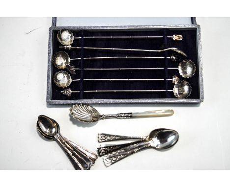 A set of six Japanese silver stirrers/swizzle spoons, stamped 'Sterling 950', with various Oriental motifs to the finials, ca