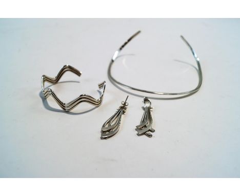A torque necklace; a bangle; and a pair of earrings; all stamped '925'