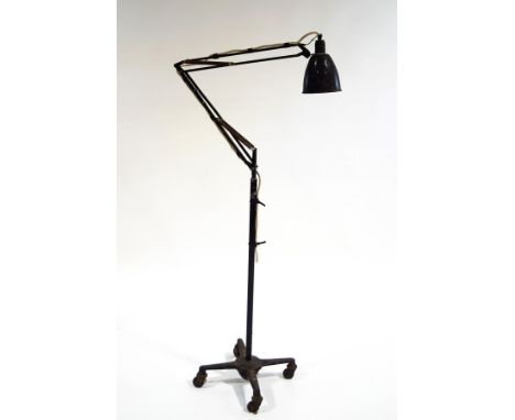 An Anglepoise floor lamp on a four pronged base with casters