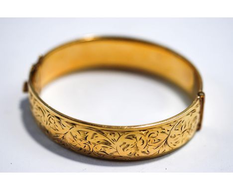 A rolled gold hinged bangle