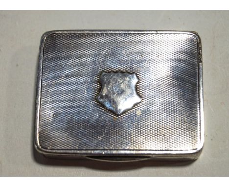 An Asprey silver engine turned rectangular vesta/match case in the form of a snuff box, the hinged cover with an applied vaca