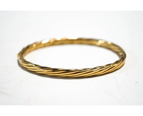 A 9ct gold rope-twist bangle, post 2000 convention hallmarks and stamped '9kt', 10.6g