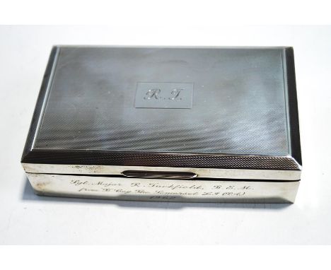 A rectangular silver cigarette case, the top with engine turned decoration and engraved with initials R.F., the side engraved