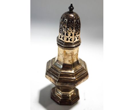 A silver octagonal baluster shaped sugar caster, the pierced cover with a baluster finial, hallmarks for Birmingham 1920 by A