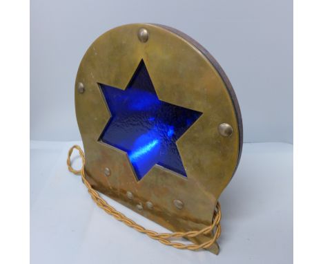 A brass and cast iron lamp with blue glass shade 