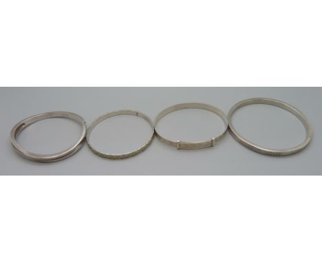 Three silver bangles, 46g, and a white metal bangle, 32g 