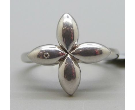 A silver ring set with a small diamond 