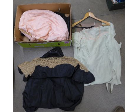 A collection of lady's vintage clothing, a riding crop and a pair of jodhpurs 