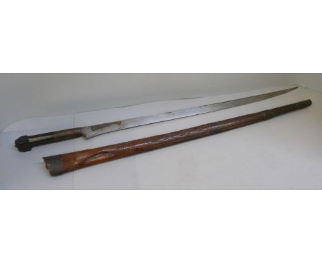 A North African Flyssa knife and wooden scabbard, scabbard and handle a/f, length in scabbard 68cm