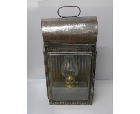 A large late 19th Century carriage lamp with three bevelled glass panels, one side glass cracked 
