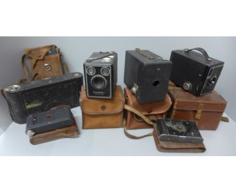 A box of vintage folding and box cameras including Kodak 