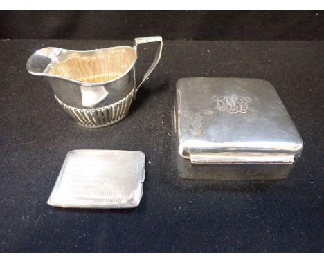 A SILVER CIGARETTE BOX, a silver engine turned match case and a silver milk jug (c.3.3oz)