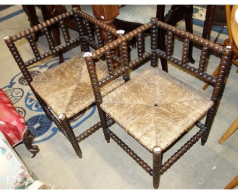 A PAIR OF VICTORIAN BOBBIN TURNED CORNER CHAIRS with rush seats