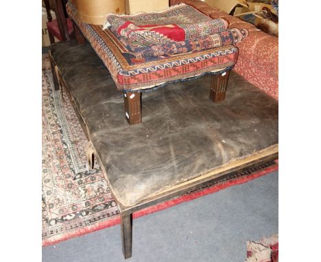 A LARGE FOOTSTOOL made from a vintage leather gymnasium mat on a modernist steel frame, 106cm x 175cm