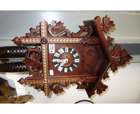 A CUCKOO CLOCK with carved and marquetry decoration (West German)