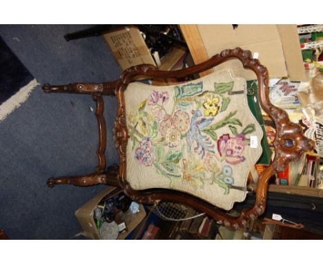 A VICTORIAN WALNUT CHEVAL FIRESCREEN of rococo design with a later floral needlework panel, 61cm wide x 112cm high