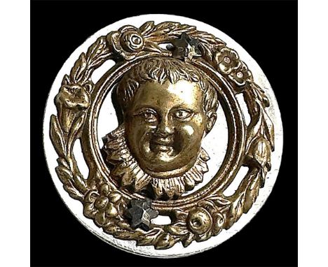 1 Large 19th century brass and steel button. This high relief and detailed brass head of a baby is pinned to a flat steel bas