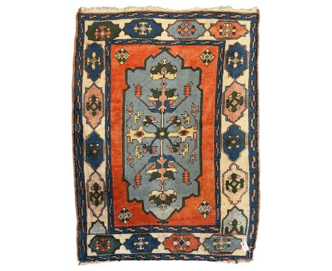 Turkish indigo ground rug, the shaped central field decorated with a central geometric stylised plant motif, enclosed with a 