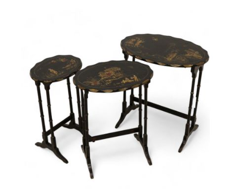 Edwardian Chinoiserie nest of three tables, oval scalloped top decorated with traditional figures and pagodas in raised giltw