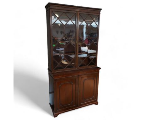 George III mahogany bookcase on cupboard, moulded dentil cornice over two astragal glazed doors, fitted with four internal sh