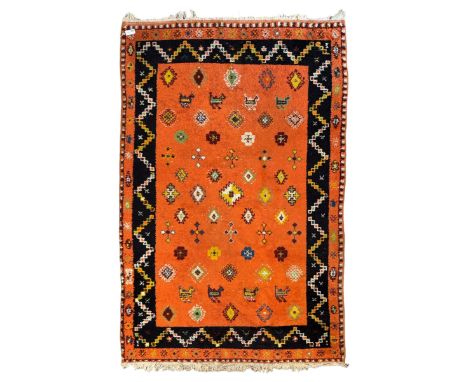 Moroccan amber ground thick pile rug, the field decorated with stylised geometric lozenges and roods, interspersed with camel