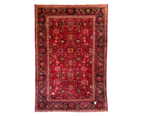 Persian Nanaj crimson ground carpet, the busy field filled with interconnecting stylised plant motifs with scrolling branches