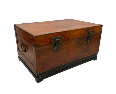 Chinese leather bound and wooden trunk, fitted with metal locks and twin carrying handles, on ebonised stand Dimensions: Heig