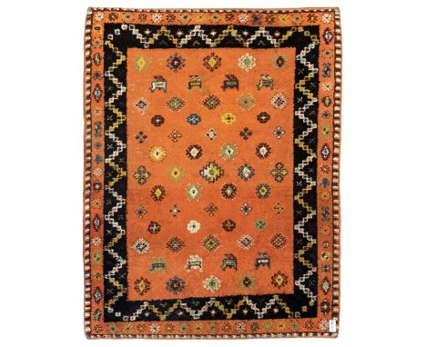 Moroccan amber ground thick pile rug, the field decorated with stylised geometric lozenges and camel motifs, the guard bands 