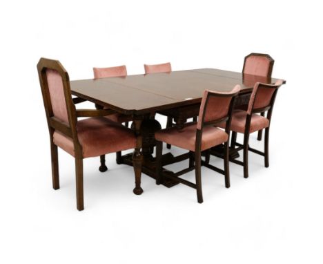 Early 20th century heavily carved oak draw leaf dining table, shaped rectangular top with recessed bead moulded edge, grape-v