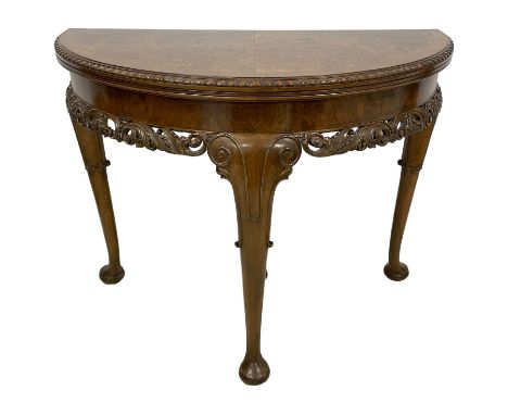 Early to mid-20th century figured walnut demi-lune card table, book-matched veneers top with crossbanding and gadroon carved 