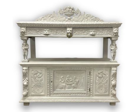 Victorian white painted heavily carved oak buffet, shaped pediment decorated with central urn filled with fruit flanked by wi