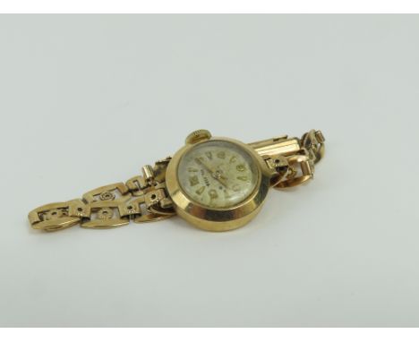 Helvetia - a ladies 9ct gold wrist watch case, the round light coloured dial with gold hands, dart baton and Arabic numerals,