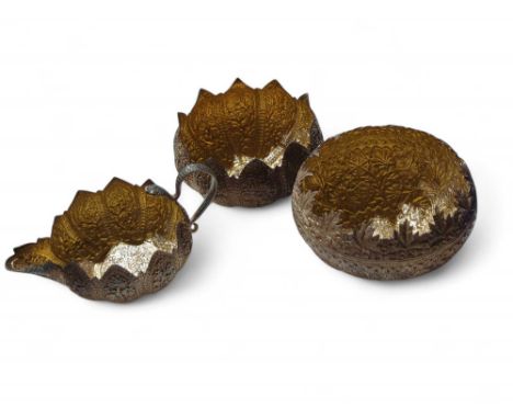Two decorative bowls alongside a small matching jug. The items either silver or silver plated, with Indian floral embossments