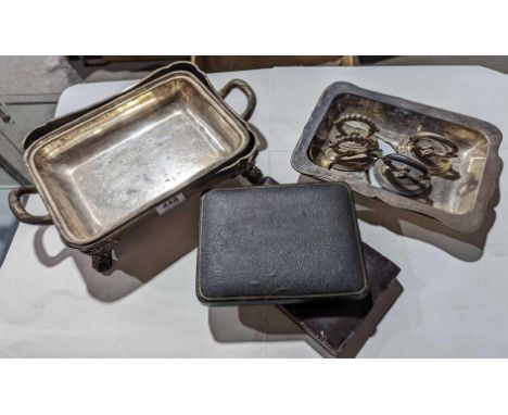 Two cases of silver flatware alongside a selection of silver-plated trays and other items, including a large tray with handle