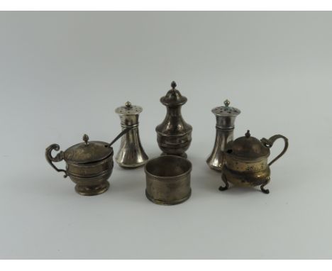 A small collection of mixed silver, comprising a pair of pepperettes, pair of cruets, salt shaker and silver napkin ring, 6.3