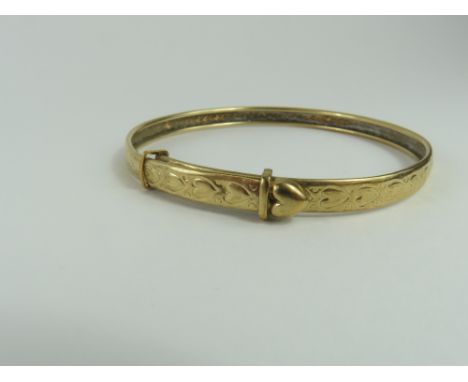 An unmarked gold expanding bangle, decorated with hearts throughout, 6.2g gross