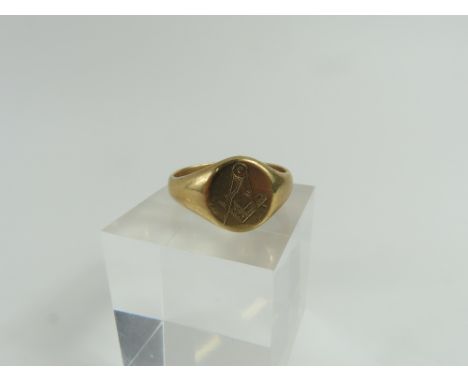 A signet ring, the round head engraved with a set square and compass, marked '9ct', finger size U1/2 leading edge, 6.4g gross