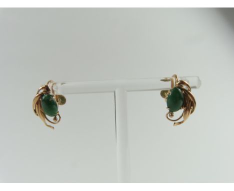 A pair of jade screw on earrings, the oval cabochon cut stones in decorative mount, marked '14k', 3.5g gross