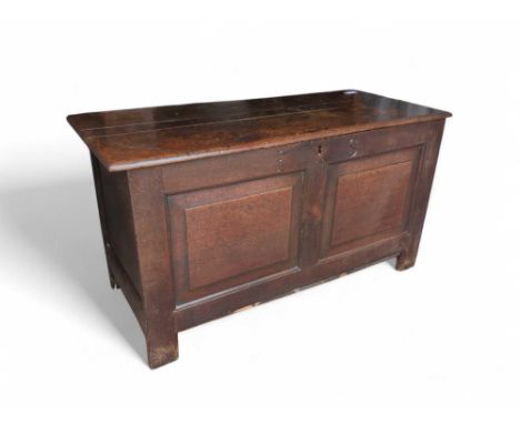 A 19th-century stained-oak coffer on four straight legs, of panelled form, possibly with replaced hinges. The base bulging in