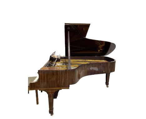 A Steinway &amp; Sons grand piano in figured mahogany case on tapering square supports and brass caters, serial no 381712,  2