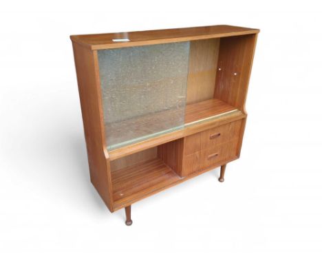 A mid-century-style cabinet with sliding glass doors, an adjustable shelf and two small drawers. Upon four pin feet with roun
