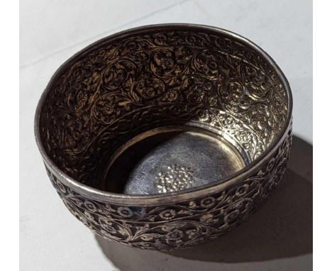A silver or silver-plated bowl with floral embossment and round plinth base. Maker's mark not visible. 5.5cm tall, 3.67 Troy 