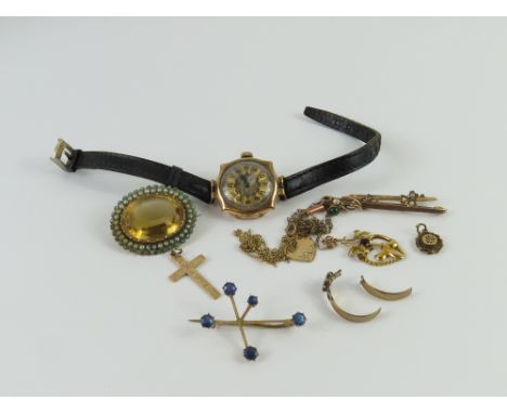 A patterned cross marked '9c', a 9ct gold bar brooch set with simulated pearls, a heart pendant marked '9ct', a fine gold cha