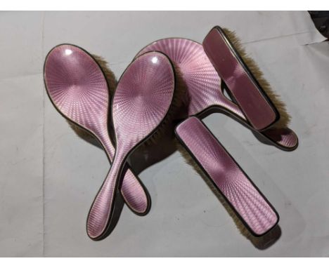 A silver-backed dressing-table set, comprising a mirror, two handled brushes and two narrow brushes, the backs with decorativ