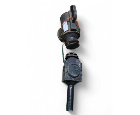 A multi aspect railway lamp together with a 19th Century black painted metal candle light (2)