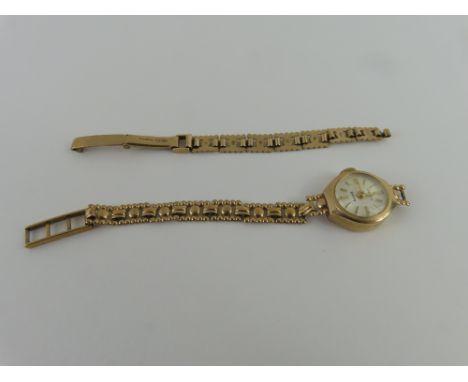 Accurist - a ladies 9ct gold wristwatch on a fancy link bracelet, the round off white dial with gold hands and baton hour mar