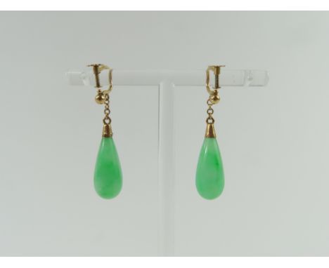 A pair of jade drop earrings, the teardrop shaped stones with a gold coloured cap and to a screw on fitting, the mounts marke