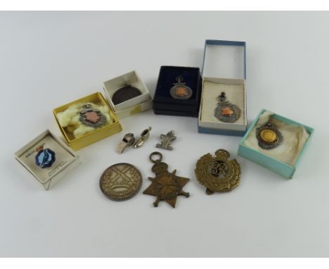 A collection of silver football medal/fobs, a National Pigeon Service badge, charms, a medal with a windmill and the inscript