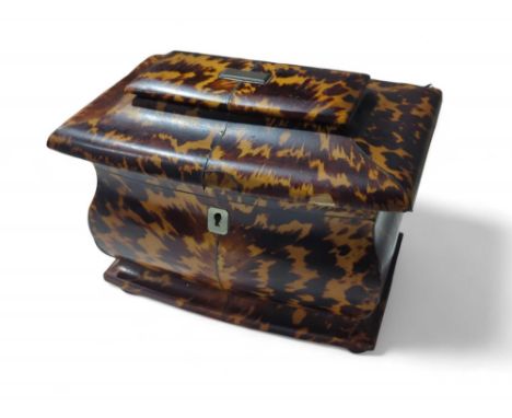 A late 19th Century tortoiseshell veneered tea caddy of bombe form, the hinged cover enclosing two compartments with shaped c
